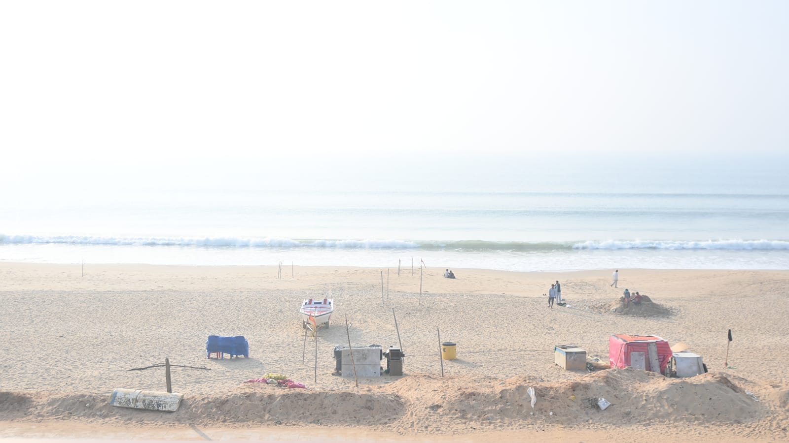 Puri Beach seen over the hotel's balcony railing, with sand and the Bay of Bengal beyond