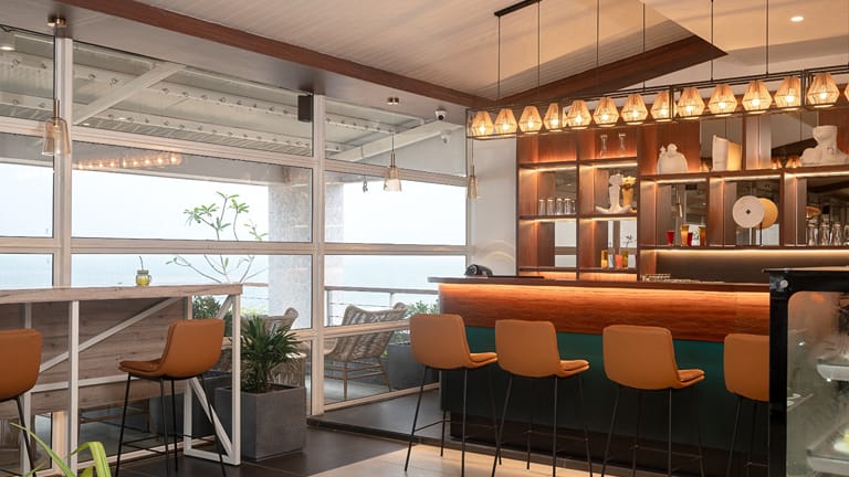 Bar counter with orange stools at the Sundowner Cafe