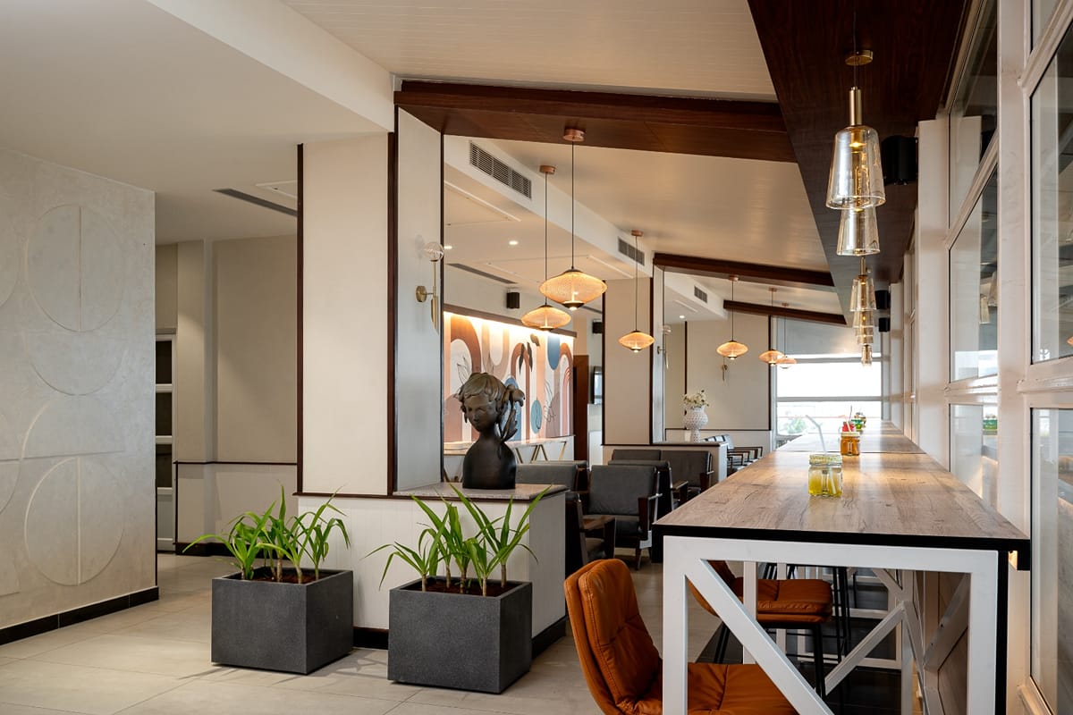 Dining area with a long wooden table and pendant lights