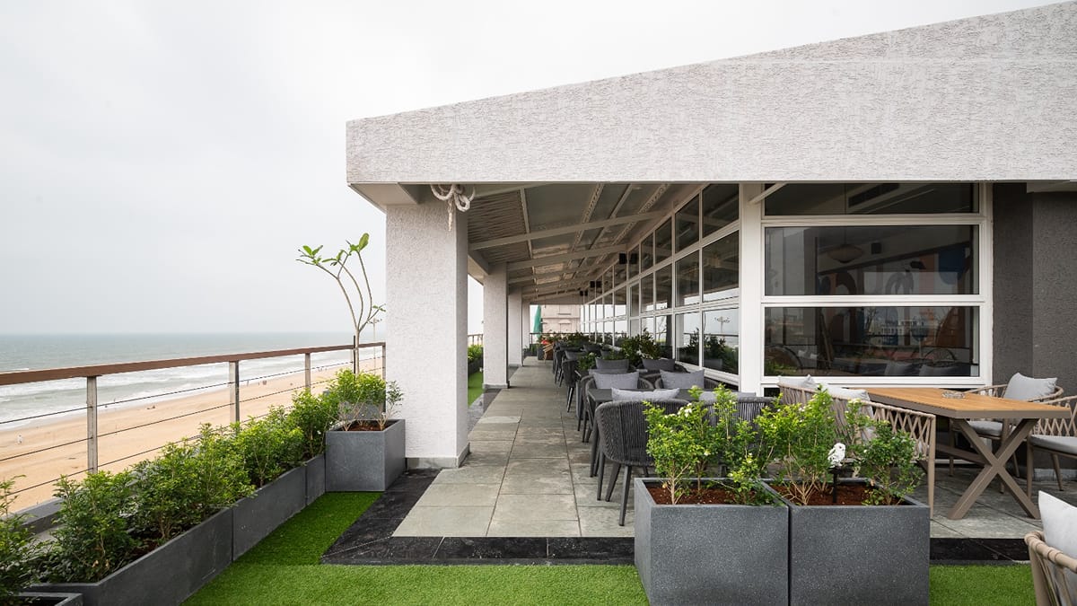 Rooftop terrace at the Sundowner Cafe with outdoor seating facing the sea