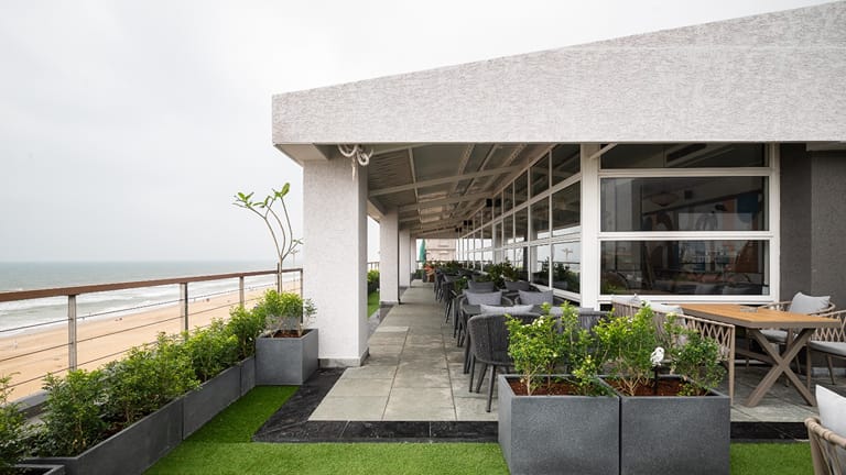Rooftop terrace seating at the Sundowner Cafe facing the sea