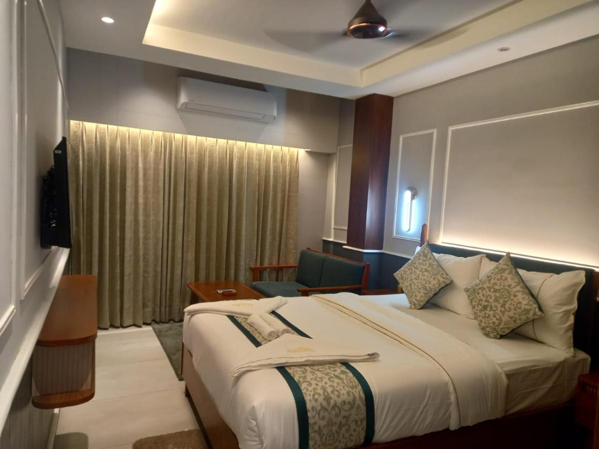 A large bed with a chair beside the window in a front sea-facing room
