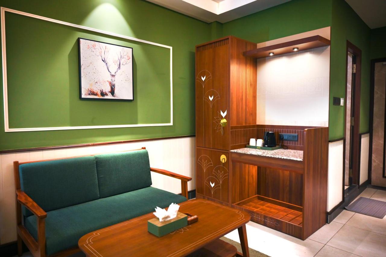 Green-walled lounge with a couch and a table