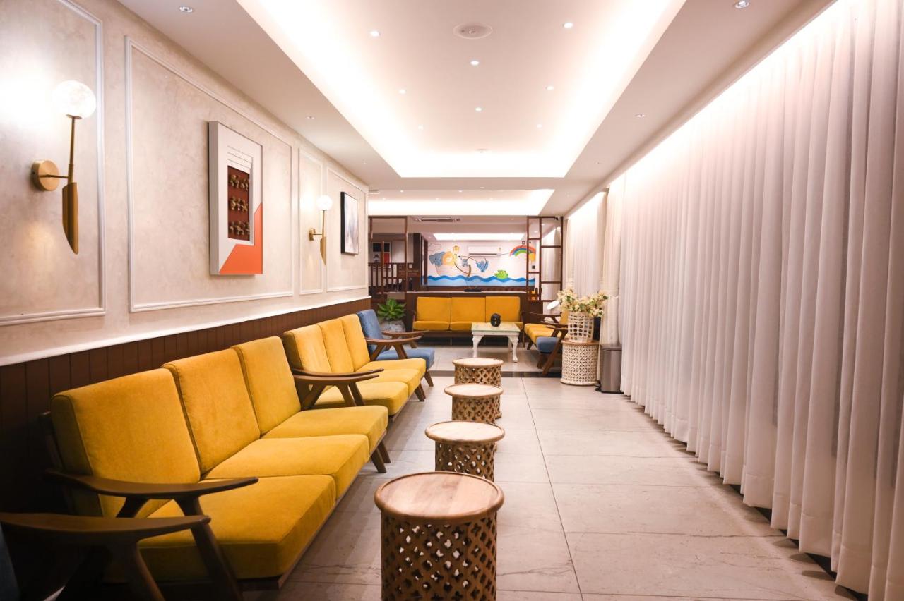 Waiting area with yellow couches and low tables