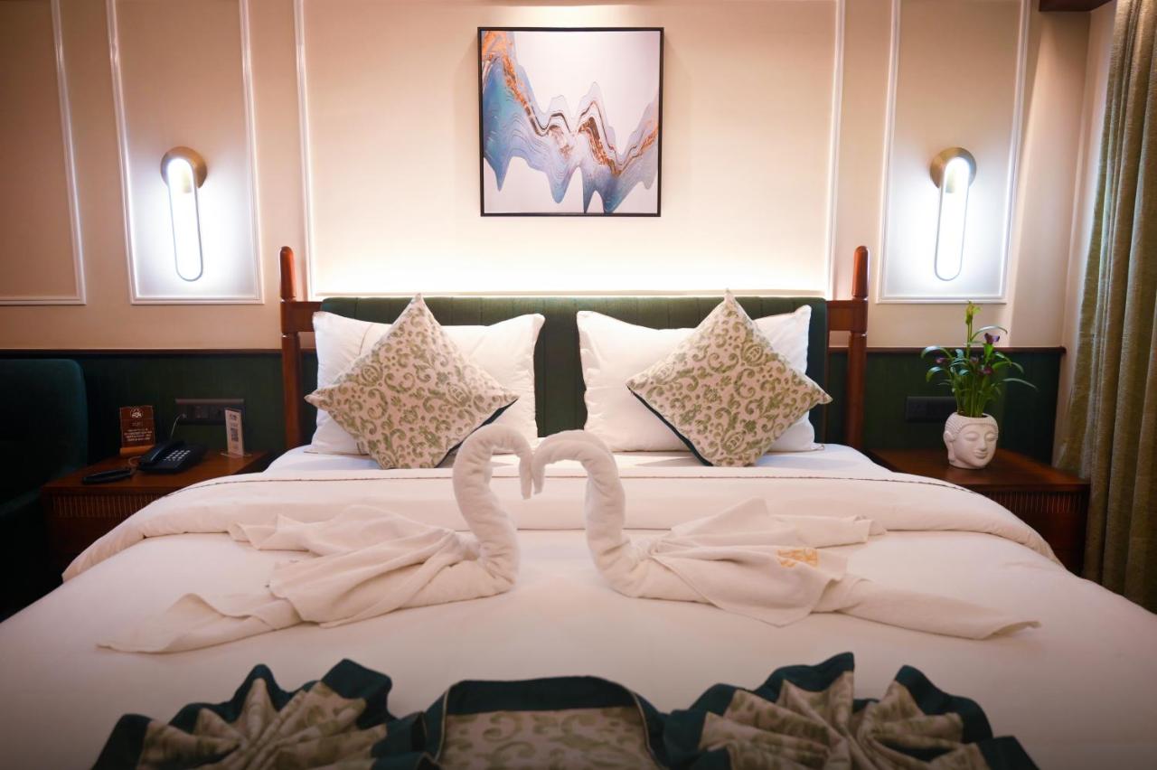 Bed dressed with two swans folded out of towels