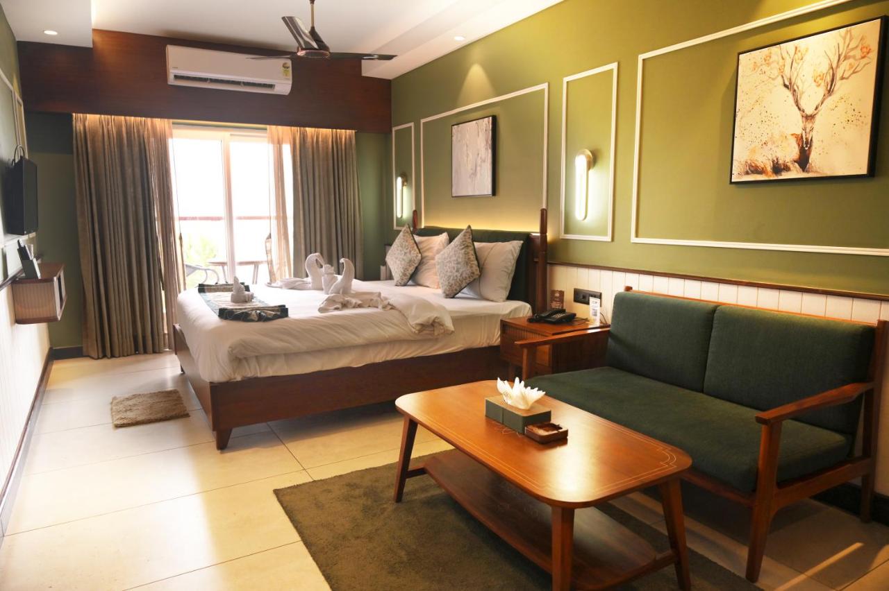 The Suite — a large bed with a sofa and coffee table beyond it