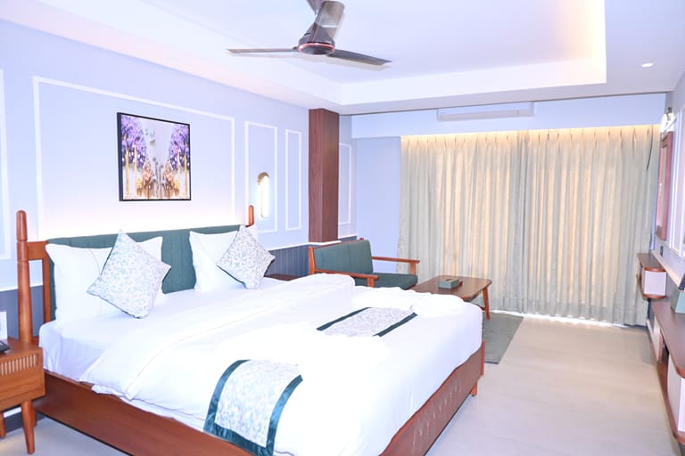 Platinum Double — king bed with a sliding door to the balcony