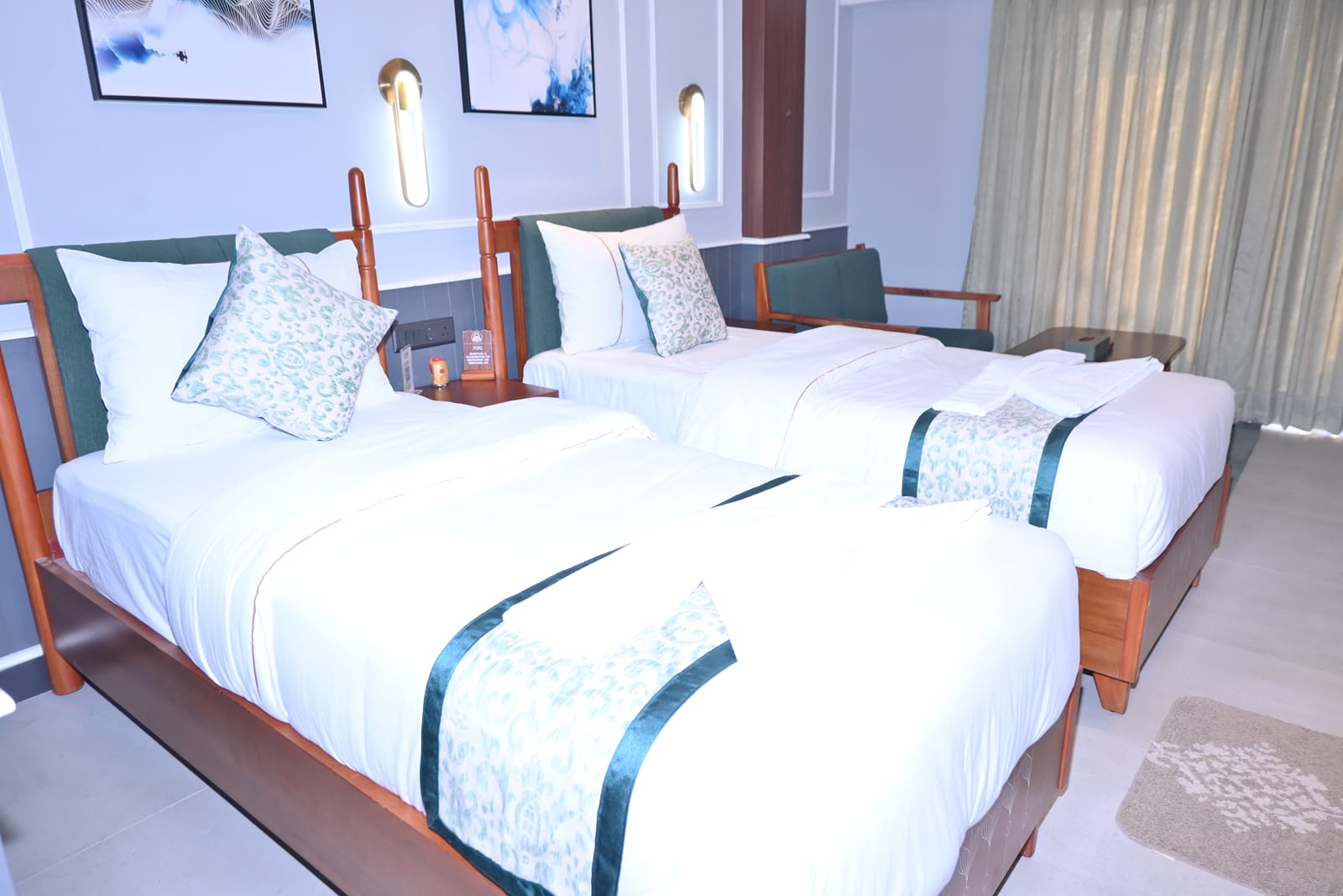 Deluxe Ground Floor Sea-View at Hotel Sonar Bangla, Puri — a bright room with white bedding and green accents